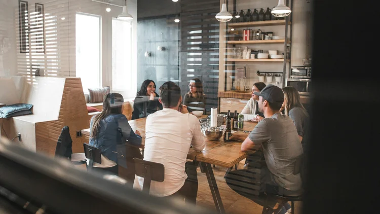 Diverse team of professionals collaborating in a strategic advisory meeting